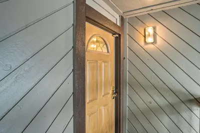 a wooden door with a light on a wall at Mammoth Lakes Condo with Pool and Spa Access! in Mammoth Lakes