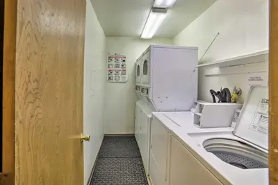 a small laundry room with a washer and dryer at Mammoth Lakes Condo with Pool and Spa Access! in Mammoth Lakes