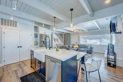 a kitchen and living room with a couch and a table at The Home at the End of the Rainbow in South Lake Tahoe