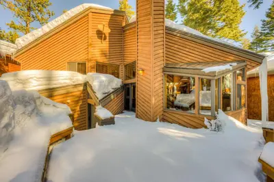 a home covered in snow in the yard at North Star Mountain Retreat in Truckee