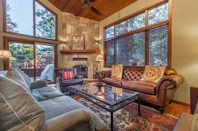 a living room with a couch and a table at Townhouse Art Gallery in Mammoth's Best Location in Mammoth Lakes