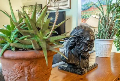a statue sitting on top of a table with plants at Townhouse Art Gallery in Mammoth's Best Location in Mammoth Lakes