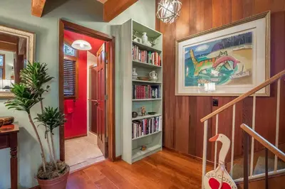 a hallway with a book shelf with books at Townhouse Art Gallery in Mammoth's Best Location in Mammoth Lakes