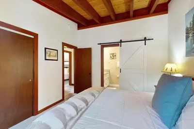 a bedroom with a large white bed in a room at Tree-Lined Views #8 in Tahoe City