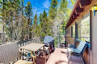 a deck with a wooden table and chairs at Tree-Lined Views #8 in Tahoe City