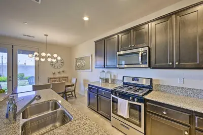 a kitchen with stainless steel appliances and a dining room at Visalia Home with Yard 4 Mi to Downtown! in Visalia