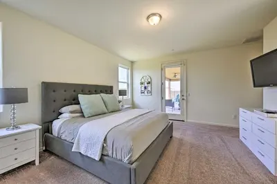 a bedroom with a large bed and a television at Visalia Home with Yard 4 Mi to Downtown! in Visalia