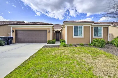 a house with a driveway and a garage at Visalia Home with Yard 4 Mi to Downtown! in Visalia