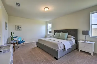 a bedroom with a large bed and a window at Visalia Home with Yard 4 Mi to Downtown! in Visalia