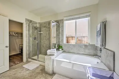 a large bathroom with a tub and a shower at Visalia Home with Yard 4 Mi to Downtown! in Visalia