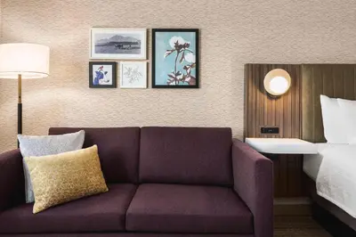 a living room with a couch in a hotel room at Hampton Inn Stockton, Ca in Stockton