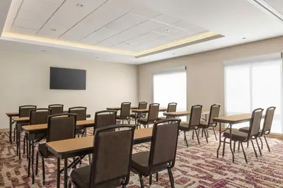 a conference room with tables and chairs and a screen at Hampton Inn Stockton, Ca in Stockton