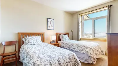a bedroom with two beds and a window at Sunstone #231 condo in Mammoth Lakes