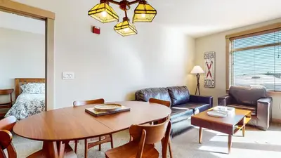 a living room with a table and a couch at Sunstone #231 condo in Mammoth Lakes