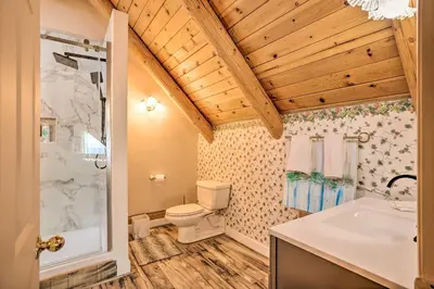 a bathroom with a toilet and a shower and a sink at Stunning Log Cabin with Great Views, Firepit, Deck near Twain Hart in Sonora