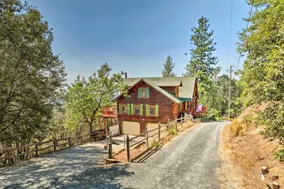 a log home on a dirt road at Stunning Log Cabin with Great Views, Firepit, Deck near Twain Hart in Sonora