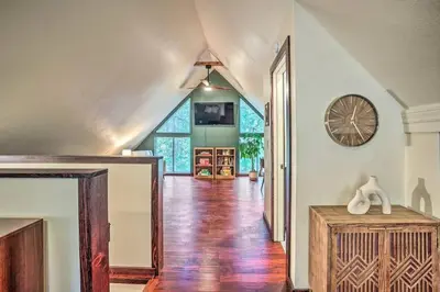 a hallway of a home with a clock on the wall at Peaceful Oak Haven Cabin near Yosemite in Mariposa