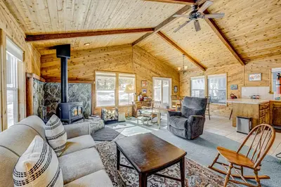 a living room with a couch and a stove at The Big White Cottage in Truckee