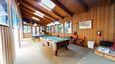 a room with a pool table in a house at Mammoth Estates #140 condo in Mammoth Lakes