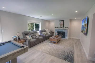 a living room with a couch and a pool table at Creek Side Summit home in Stateline