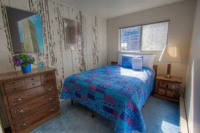 a bedroom with a bed and a dresser and a window at Life's Better The Milky Way condo in Stateline