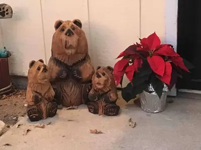three bear statues sitting next to a vase with flowers at Sierra Sunset Cottage -Yosemite area vacation cottage in Ahwahnee