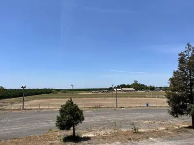 an empty parking lot with a tree in the middle at Adorable 1 Bedroom with pool, and Horse Arena in Oakdale
