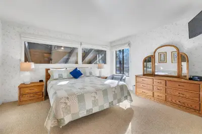 a bedroom with a large bed and a large mirror at Three-Bedroom House in South Lake Tahoe