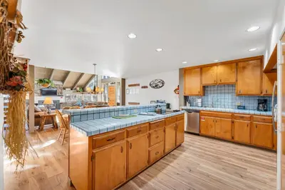 a large kitchen with wooden cabinets and a counter top at Three-Bedroom House in South Lake Tahoe
