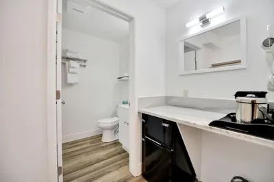 a white bathroom with a sink and a toilet at Amador Hotel in Pioneer