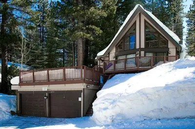 a house in the snow with a garage at Rocky Top Retreat home in South Lake Tahoe
