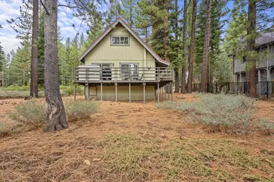 a large house in the middle of a forest at Cozy Cabin home in South Lake Tahoe