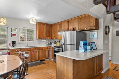 a kitchen with wooden cabinets and a stainless steel refrigerator at Cozy Cabin home in South Lake Tahoe