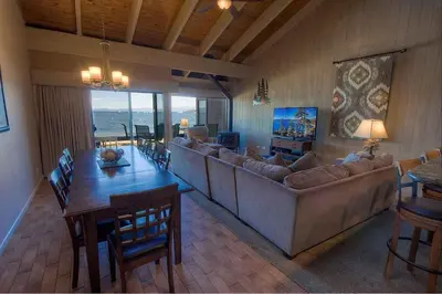 a living room with a couch and a table and a dining room at Sky Lake Splendor condo in South Lake Tahoe