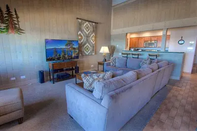 a living room with two couches and a kitchen at Sky Lake Splendor condo in South Lake Tahoe