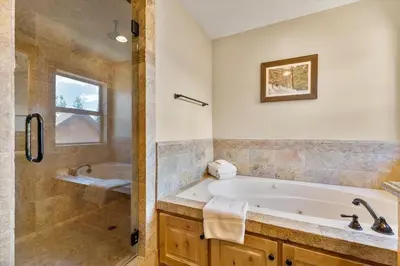 a large bathroom with a tub and a shower at Shaquinaw! home in South Lake Tahoe