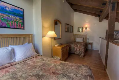 a bedroom with two beds and a lamp and a mirror at Bear Lake Hideaway condo in South Lake Tahoe