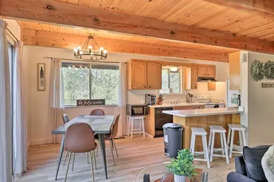 a kitchen and living room with a table and chairs at Pine Mountain Lake Cabin with Grill! in Groveland