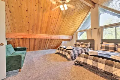 a bedroom with two beds and a ceiling fan at Pine Mountain Lake Cabin with Grill! in Groveland
