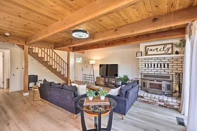 a living room with couches and a fireplace at Pine Mountain Lake Cabin with Grill! in Groveland