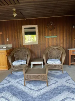 two wicker chairs and a table on a patio at Twain Harte Cabin in Town & Lake access in Twain Harte