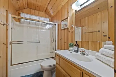 a bathroom with a sink and a shower and a toilet at Cabin #4 in Strawberry