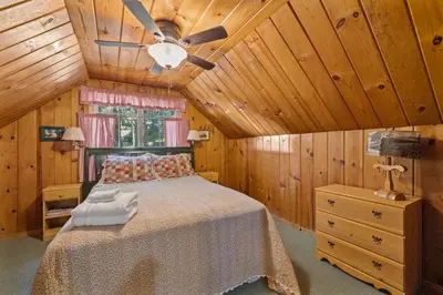 a bedroom with a bed and a ceiling fan at Cabin #5 in Strawberry