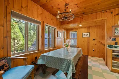 a dining room with a table and some windows at Cabin #5 in Strawberry