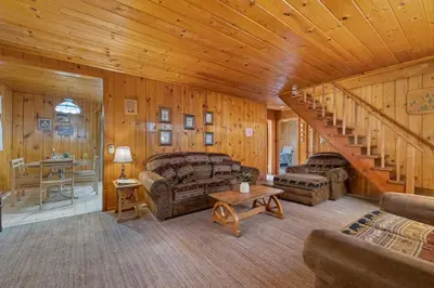 a living room with a staircase in a cabin at Cabin #2 in Strawberry