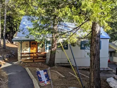 a small white house with a blue roof at Cabin #2 in Strawberry