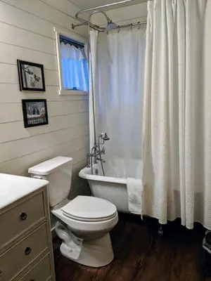 a bathroom with a toilet and a tub and a shower at Cabin #7 in Strawberry