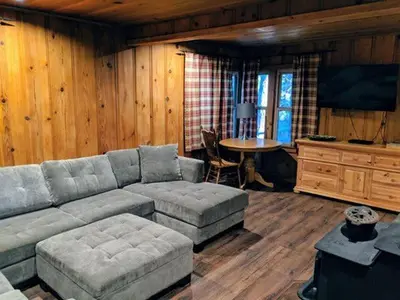 a living room with a couch and a table at Cabin #7 in Strawberry