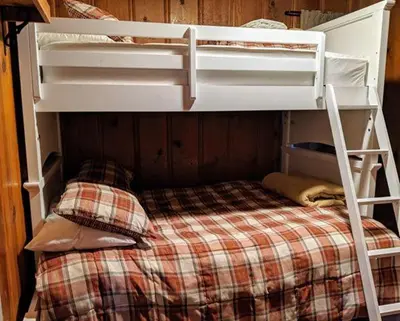 a white bunk bed with a checkered bedsheet at Cabin #7 in Strawberry