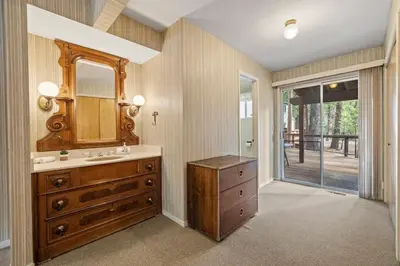 a bathroom with a wooden dresser and a sink at Cabin #10 in Strawberry